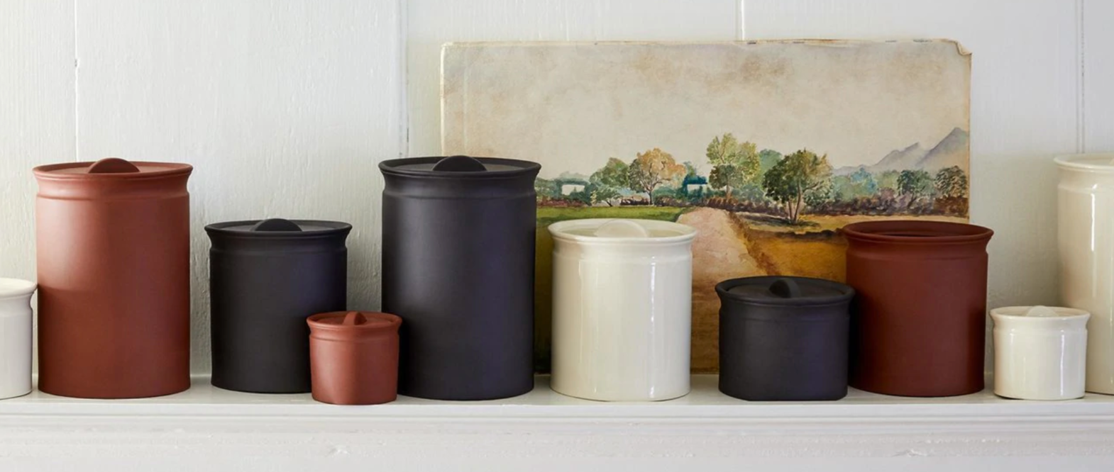 Terracotta, black and white canisters on a kitchen counter curtesy of WGSN