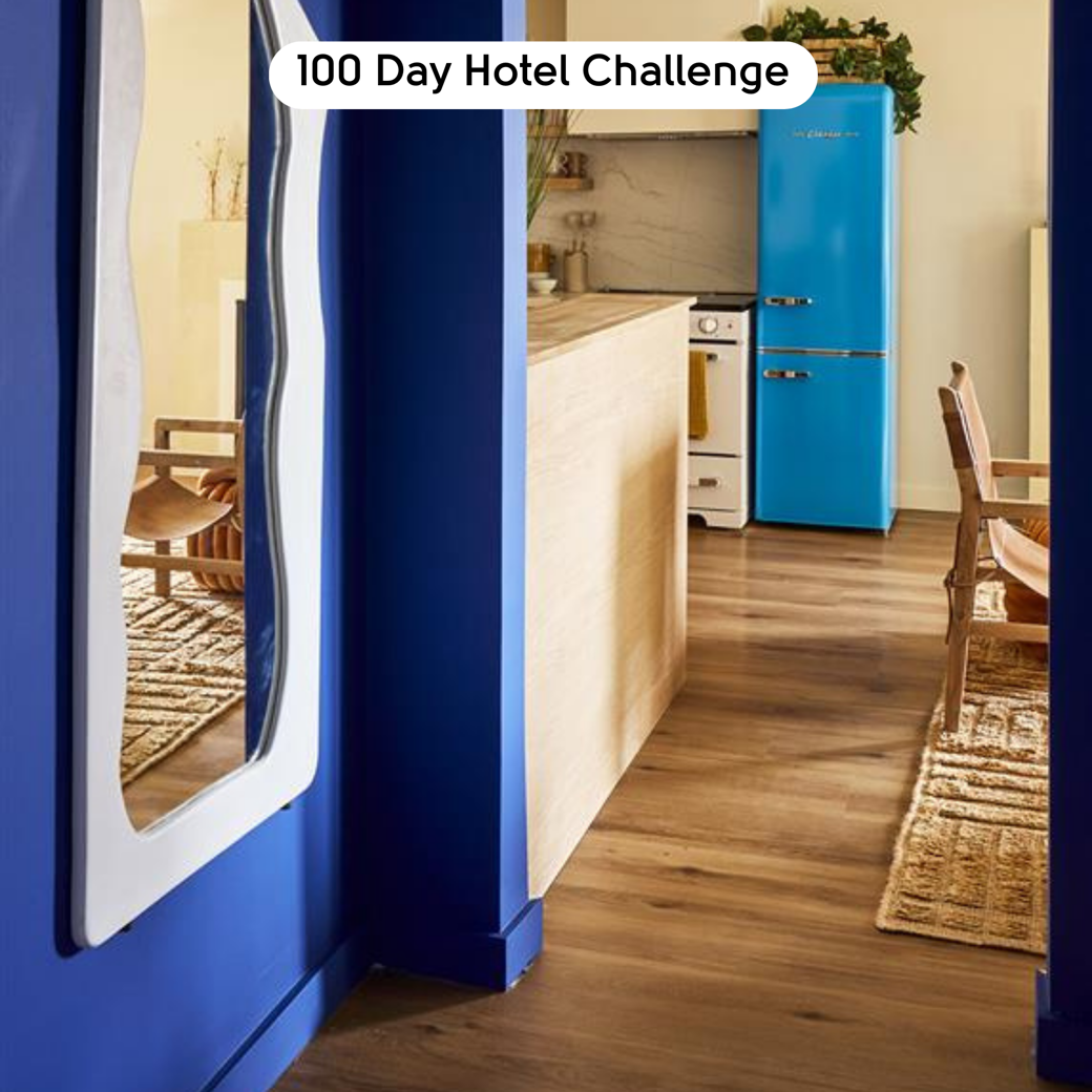 Golden Danish Oak LLP359 floors in a bright blue motel hallway designed by Brian Kleinschmidt in 100 Day Hotel Challenge